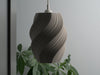 Modern gray table lamp shade, designed to enhance any space with its sculptural spiral pattern.