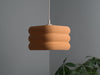 Eye-catching orange ceiling lamp shade with a pixel-textured finish, designed for warm and inviting lighting.