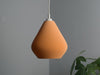 Eye-catching orange ceiling lamp shade with a pixel-textured finish, creating a warm and inviting atmosphere.