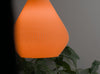 Bold orange pendant light shade with a pleated teardrop shape. Ideal for modern home decor.