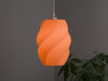 Vibrant orange spiral lampshade, a bold and modern ceiling lamp shade for stylish interiors.