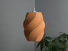 Orange wicker lamp shade with a stylish pleated spiral design. A durable and high-quality replacement lamp shade.