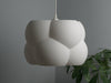 Elegant white ceiling light shade with a soft glow, perfect for creating a cozy and inviting atmosphere in any room.