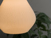 Elegant white ceiling lamp shade with a teardrop shape and pixel texture, perfect for soft lighting.