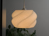 White wavy lampshade with a pleated design, perfect for ceiling lamp shades and pendant light shades in modern interiors.